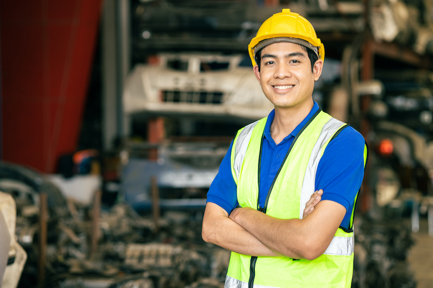 confidentasianmaleengineerworkerstandingarmcrossedhappysmile