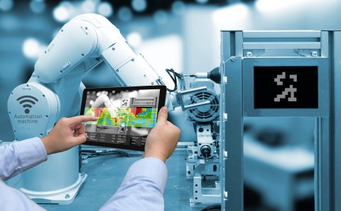 industry-4-0-concept-man-hand-holding-tablet-with-augmented-reality-screen-software-and-blue-tone-of-automate-wireless-robot-arm-in-smart-factory-background
